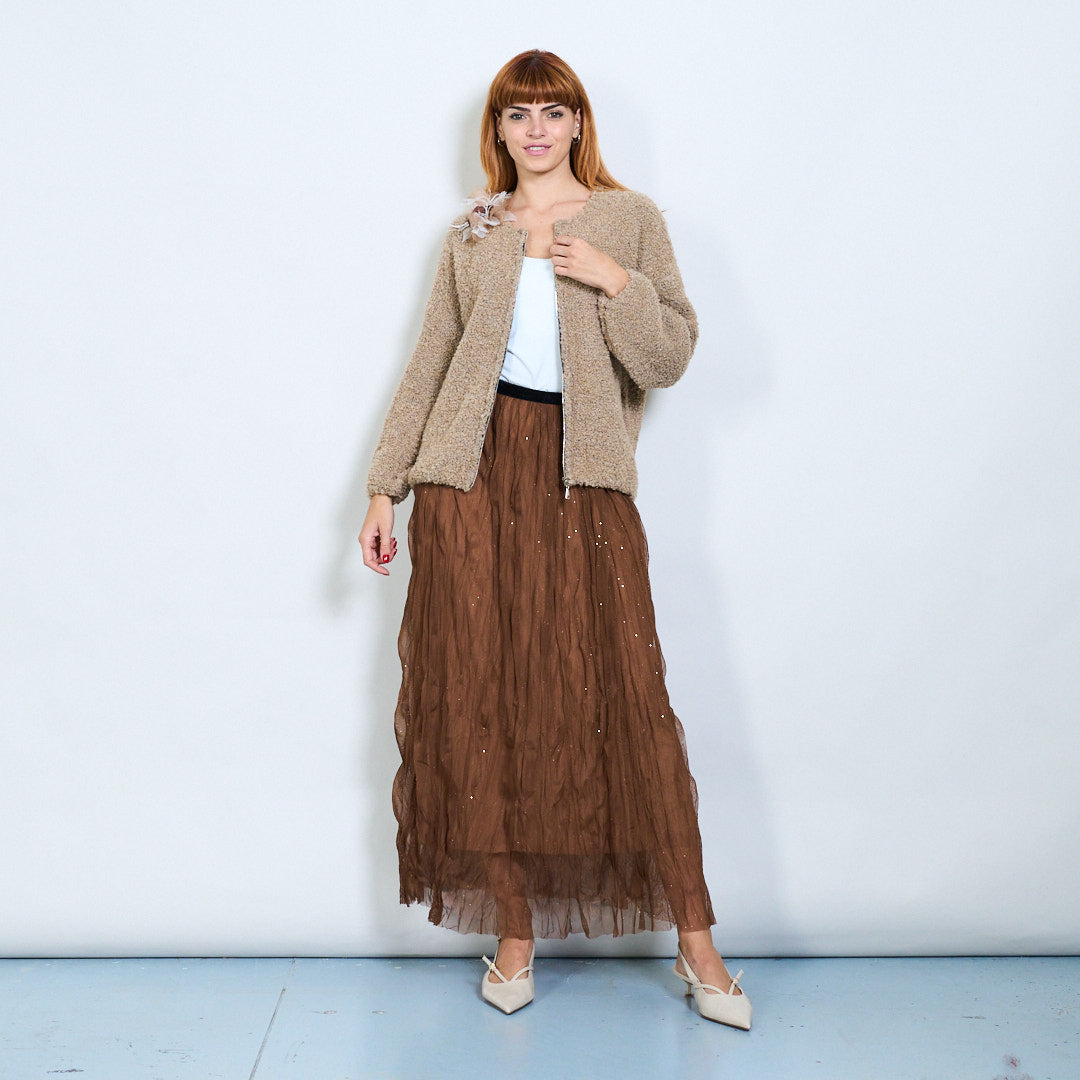 Model wearing a brown textured jacket and tulle skirt from Lamya, featured on LEIVIP fashion wholesale platform.