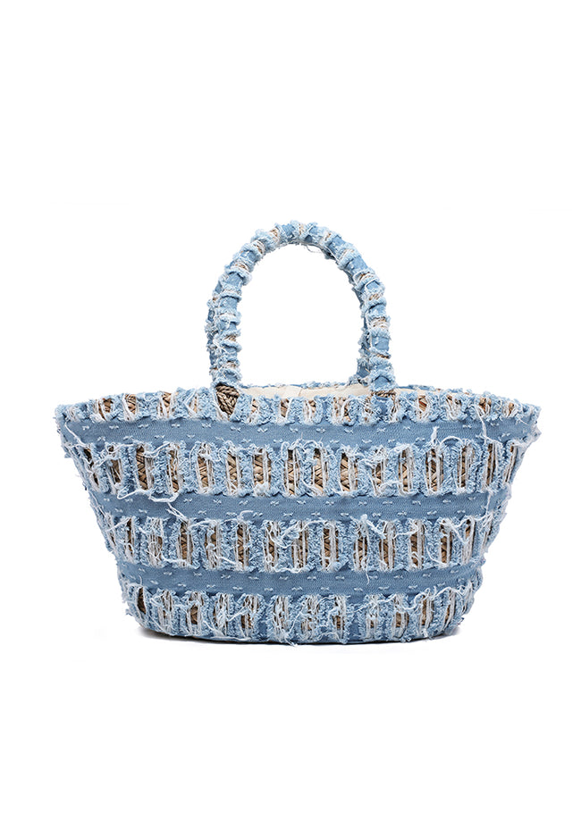 Natural woven tote bag covered with distressed blue horizontal panels and matching wrapped handles.