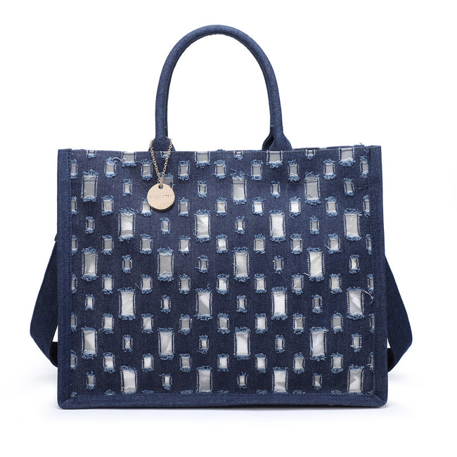 Dark blue rectangular tote bag with distressed square details, rounded handles and a round charm.