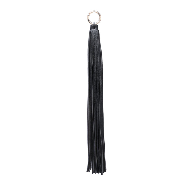 Black tassel charm with long narrow strands and a metal ring