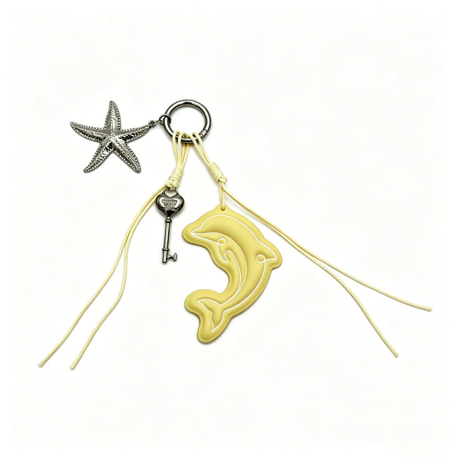 Yellow dolphin keyring with long matching cords, a starfish charm and a small key.