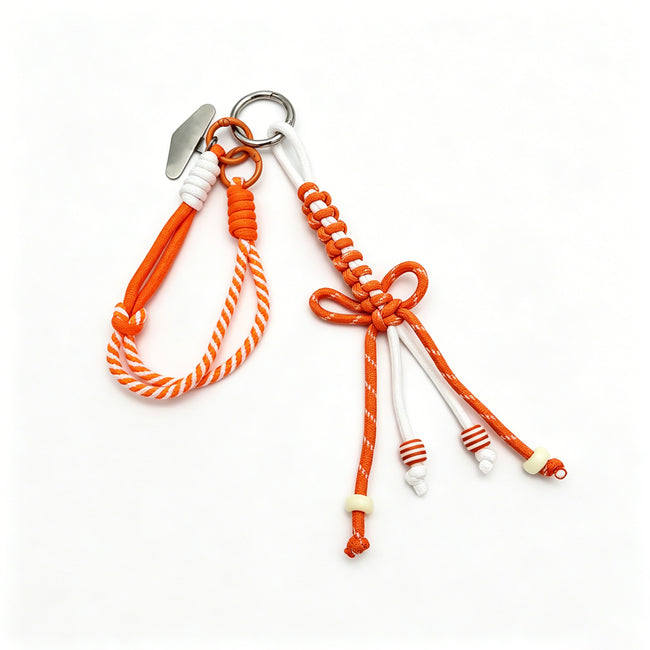 Orange-and-white rope keyring with a loop, braided bow and dangling striped beads.