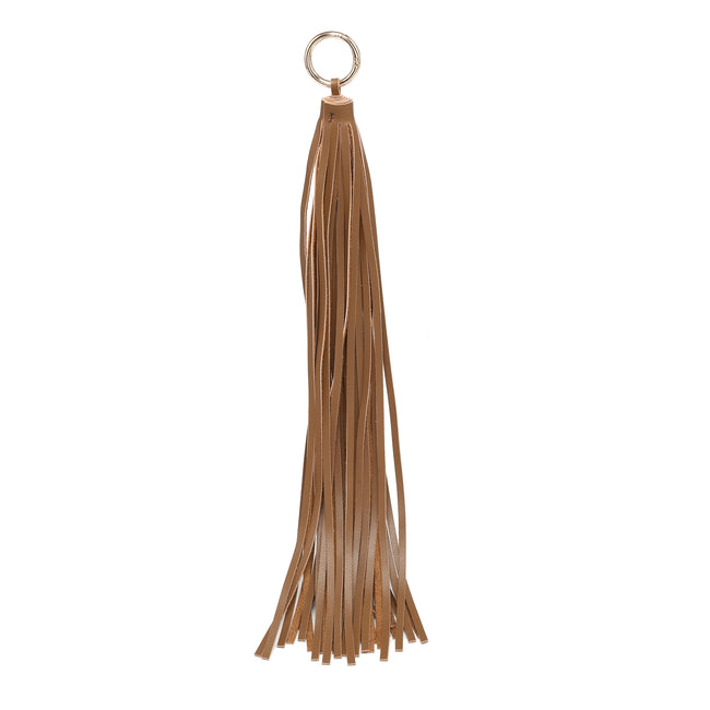 Tan tassel charm with long flat strands and a round metal ring