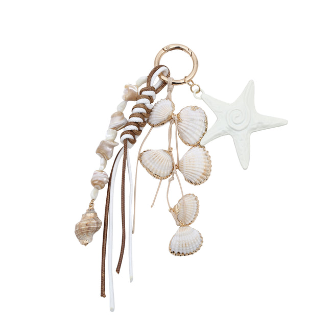Keyring with a white starfish, dangling shell charms and long white-and-brown cords.