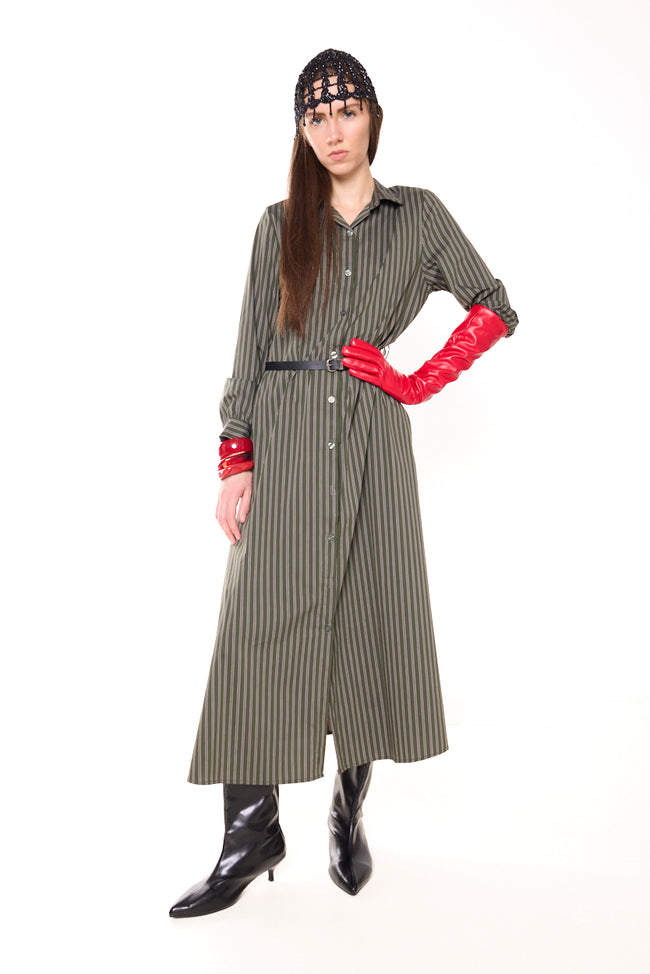 Olive green with dark stripes striped long shirt dress with pointed collar, front button placket, long cuffed sleeves and straight long hem; photographed with slim belt, gloves, lace cap and boots