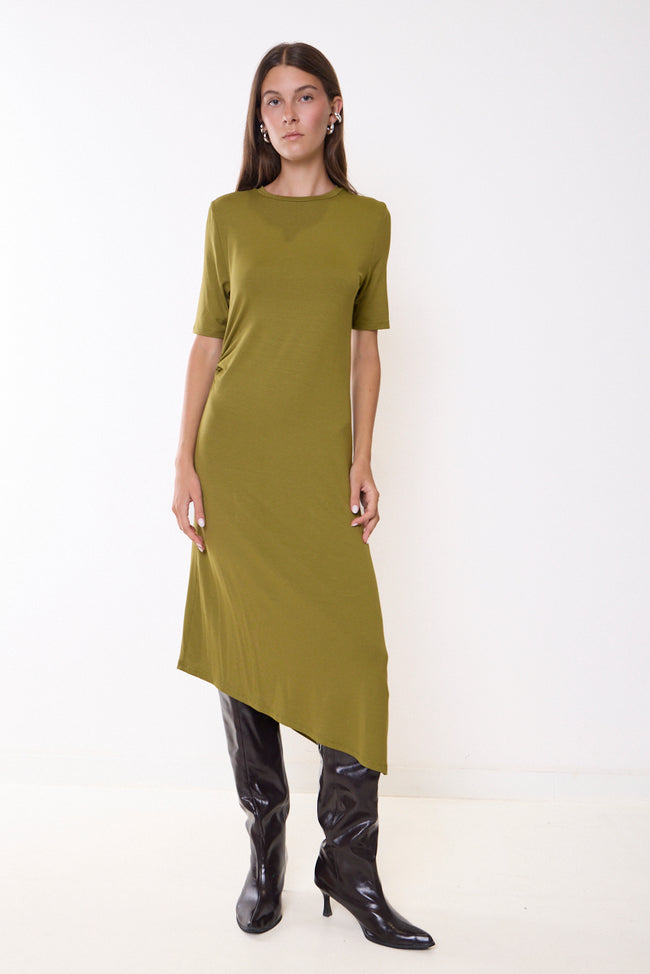Olive green round-neck short-sleeve midi dress with side gathering and asymmetric hem; boots, cap and accessories styled separately