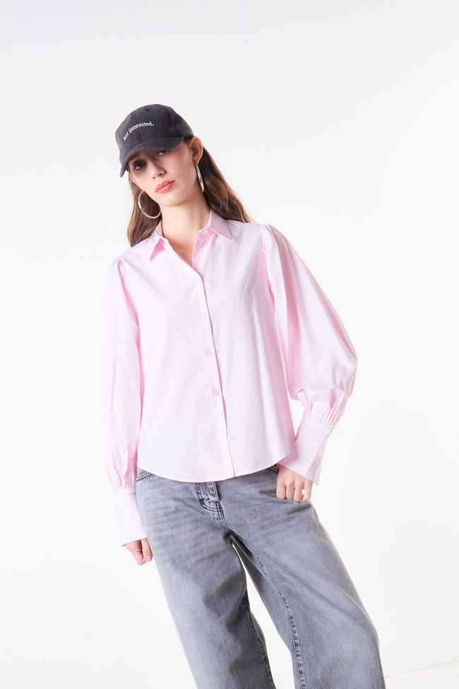 Light pink cotton-blend button-front blouse with pointed collar, long puff sleeves, wide cuffs and curved hem