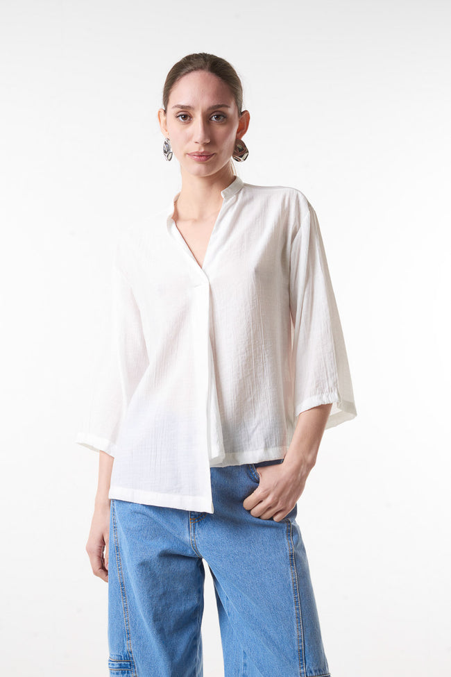 White relaxed V-neck blouse with wide three-quarter sleeves