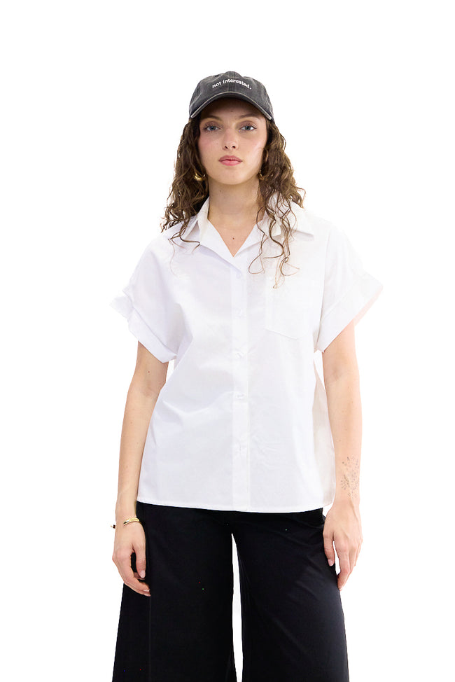 White relaxed cotton shirt with pointed collar, front buttons, rolled short sleeves and chest patch pocket