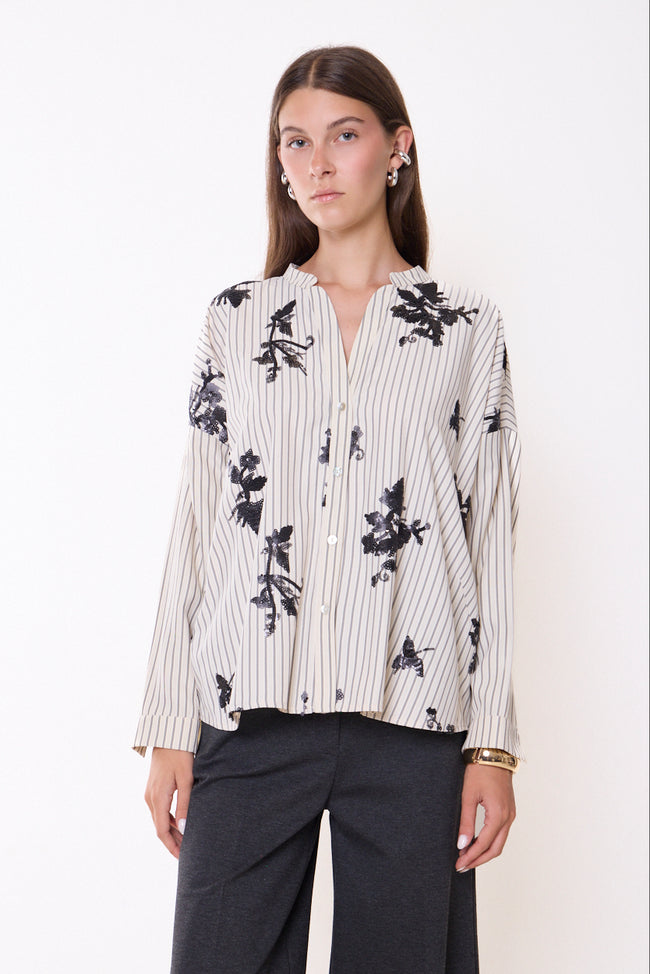 White with fine grey vertical stripes, band-collar button-front long-sleeve shirt with black floral sequin motifs; trousers and jewellery styled separately