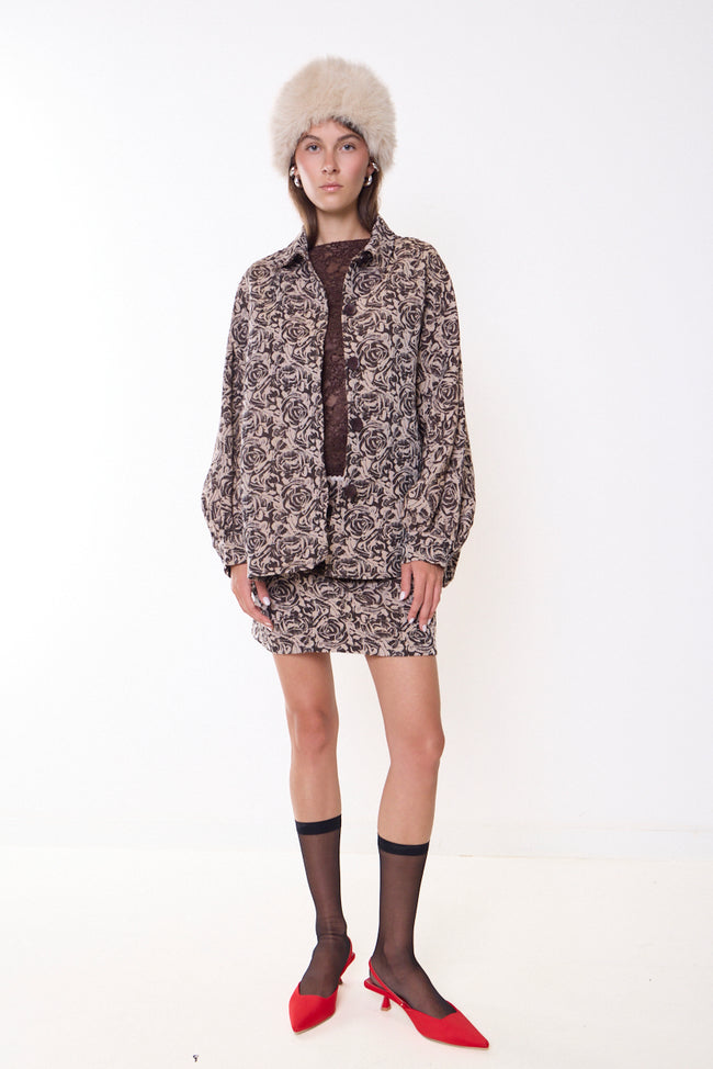 Coffee brown and cream floral rose-jacquard shirt jacket with pointed collar, front buttons, long voluminous sleeves and boxy silhouette; coordinating mini skirt, lace top and accessories styled separately