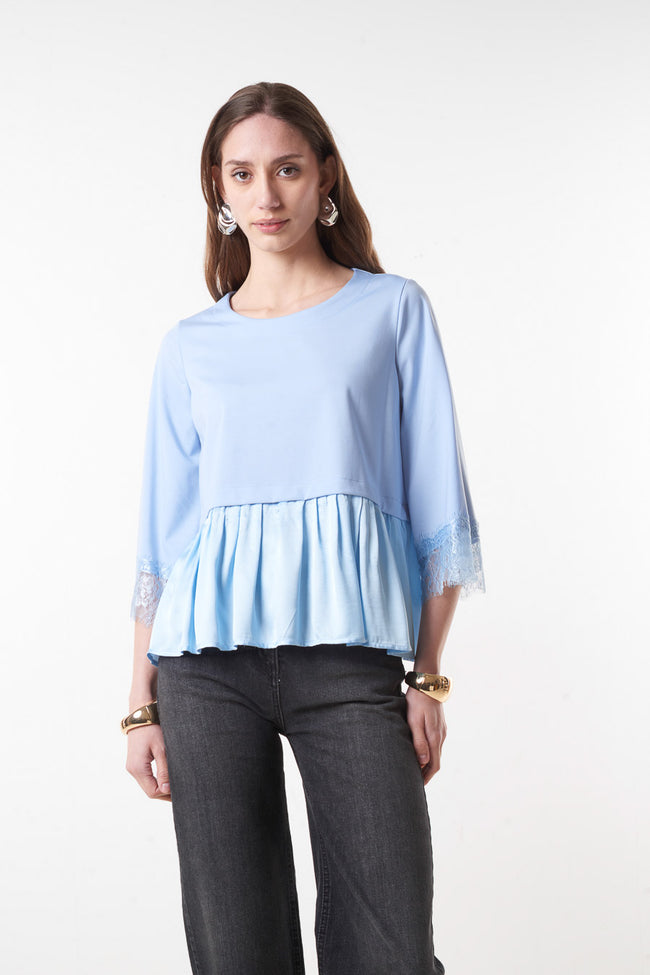Light blue round-neck peplum blouse with gathered flared hem and lace-trimmed three-quarter sleeves