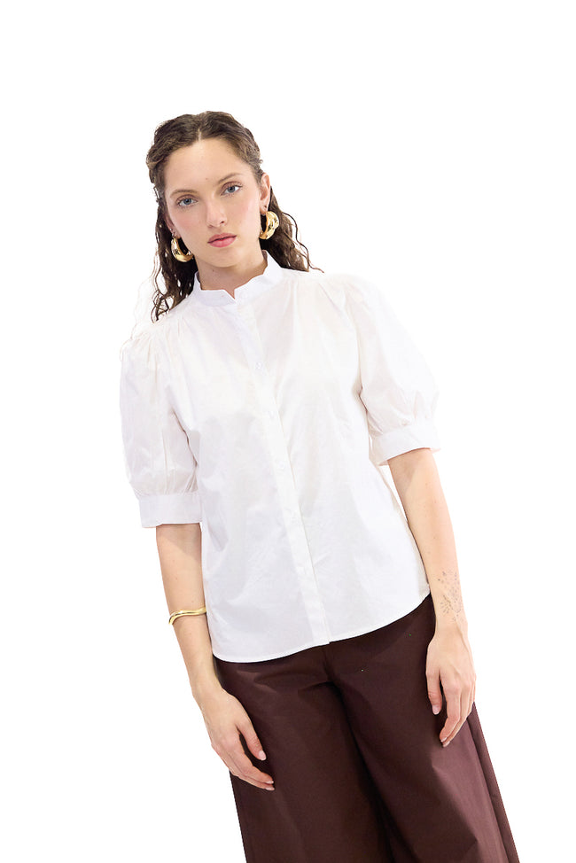 White cotton stand-collar blouse with front buttons, gathered shoulders and voluminous cuffed puff sleeves