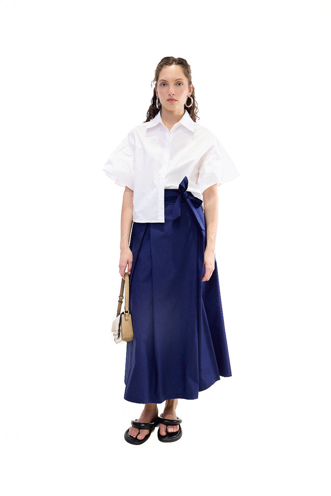 Dark blue long cotton skirt with wrap-style overlapping front, side bow tie and front opening