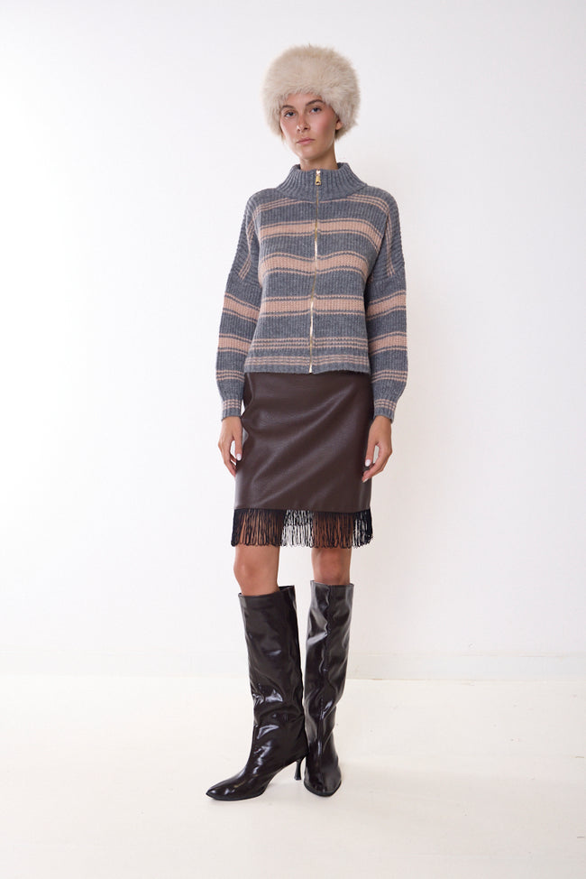 Coffee brown faux-leather mini skirt with long hanging fringe hem; striped knit cardigan, hat and boots styled separately