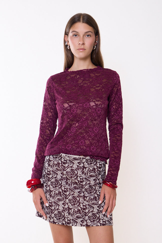 Bordeaux wine round-neck long-sleeve floral lace top with openwork texture and scalloped cuff and hem edges; skirt, bangles and jewellery styled separately