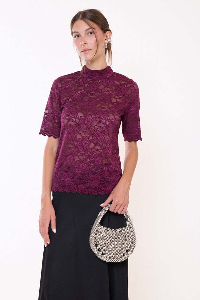 Bordeaux wine high-neck short-sleeve floral lace top with openwork texture and scalloped sleeve and hem edges; skirt, bag and jewellery styled separately