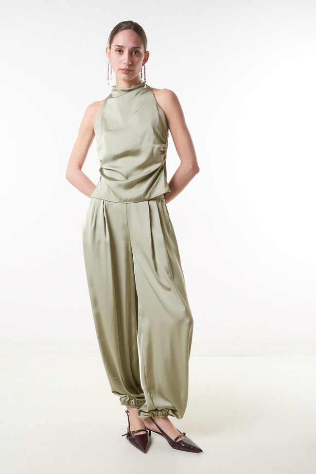 Olive green satin-finish high-waist loose trousers with side pockets and gathered ankle hems