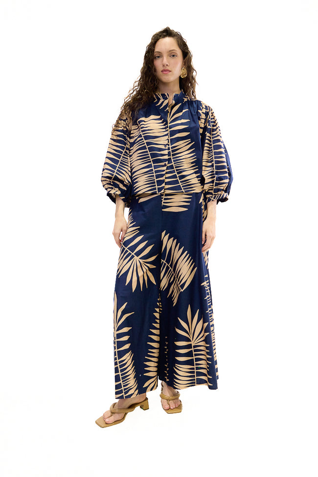Dark blue and beige cotton-elastane wide-leg trousers with large tropical palm-leaf print