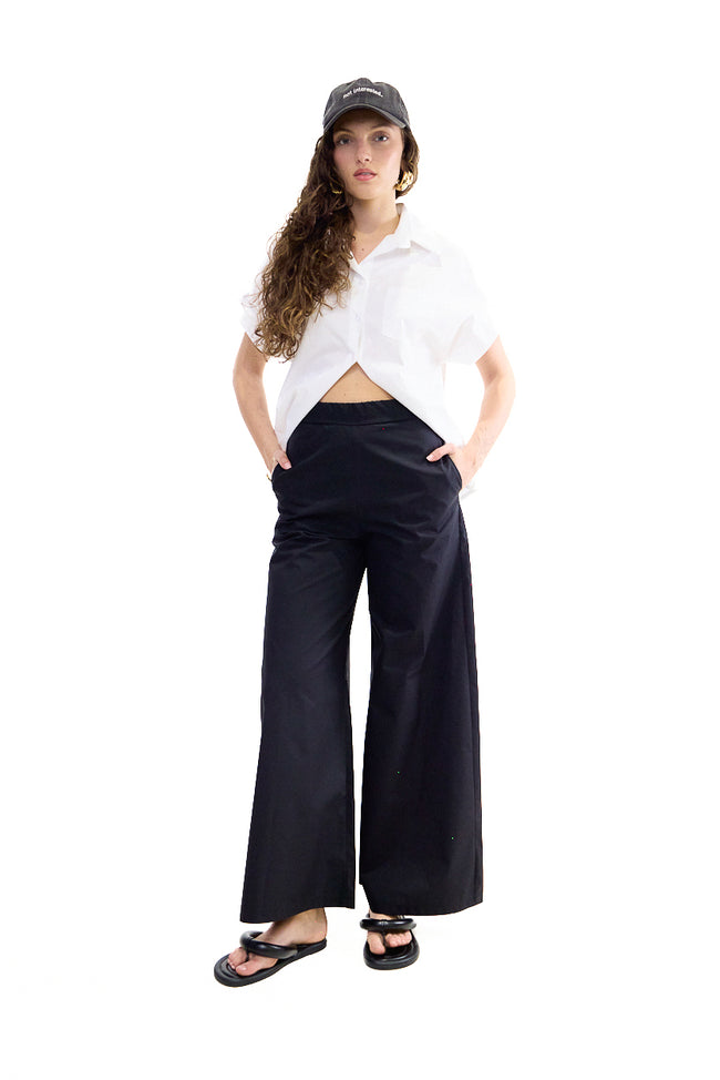 Black wide-leg cotton trousers with side pockets and relaxed cut