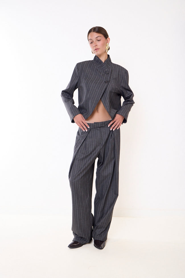 Grey pinstripe fine-pinstripe full-length wide-leg trousers with front pleats, belt loops and side pocket openings; coordinating cropped blazer, bag and jewellery styled separately