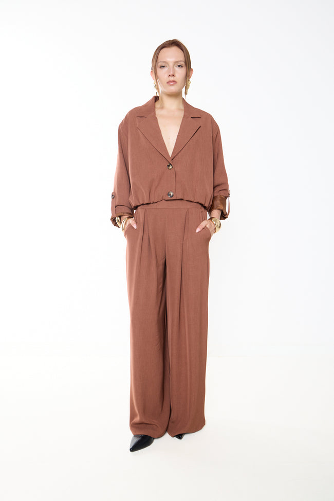 Camel rust full-length pleated wide-leg tailored trousers with side pockets; coordinating blazer, bag and earrings styled separately