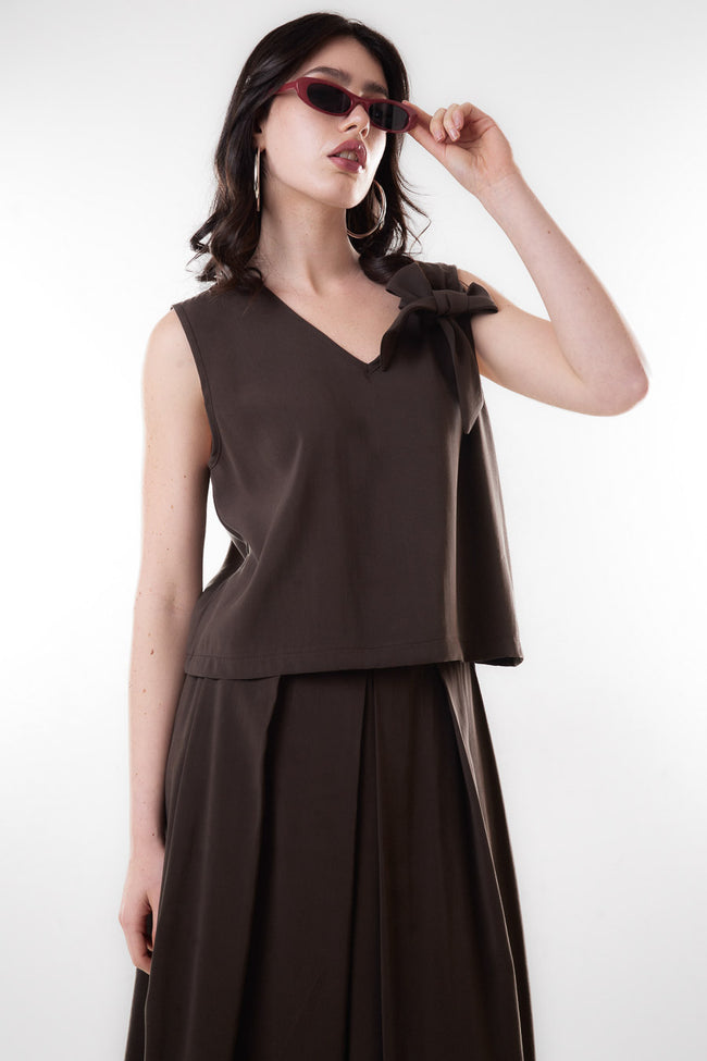 Coffee brown sleeveless modal-blend V-neck blouse with one-shoulder bow detail and relaxed silhouette