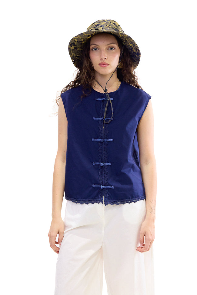 Dark blue sleeveless cotton blouse with round neckline, frog-button front details and lace trim