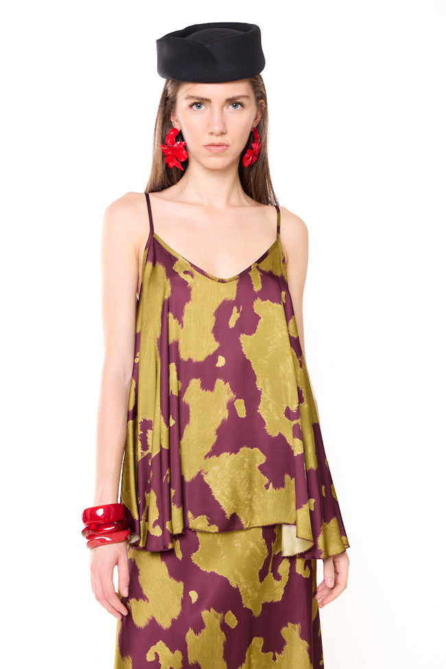 Olive-chartreuse and burgundy abstract-print viscose satin-effect camisole with V-neckline, thin straps, loose silhouette and asymmetric hem; coordinating skirt, hat and bracelets styled separately