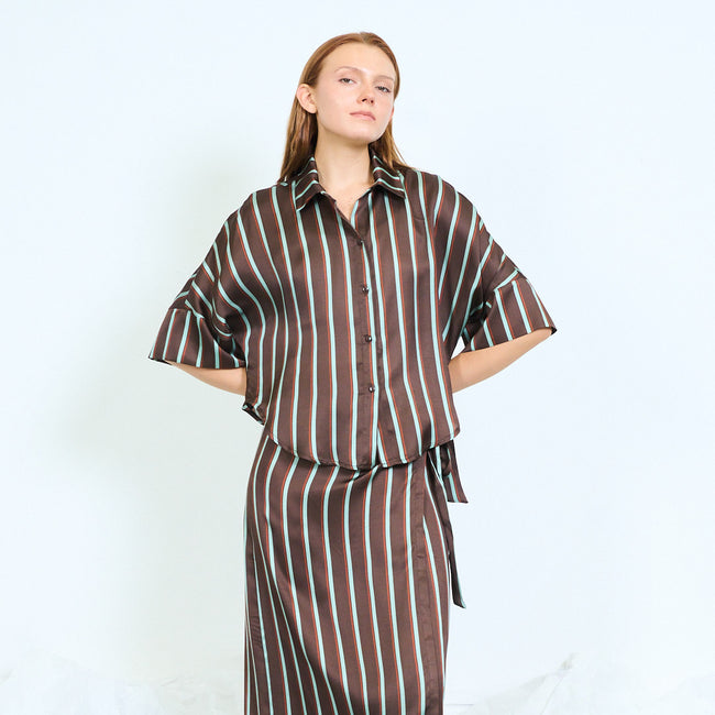 Coffee brown with teal stripes striped cropped blouse with pointed collar, front buttons, short wide sleeves and boxy silhouette; coordinating striped wrap skirt and shoes styled separately
