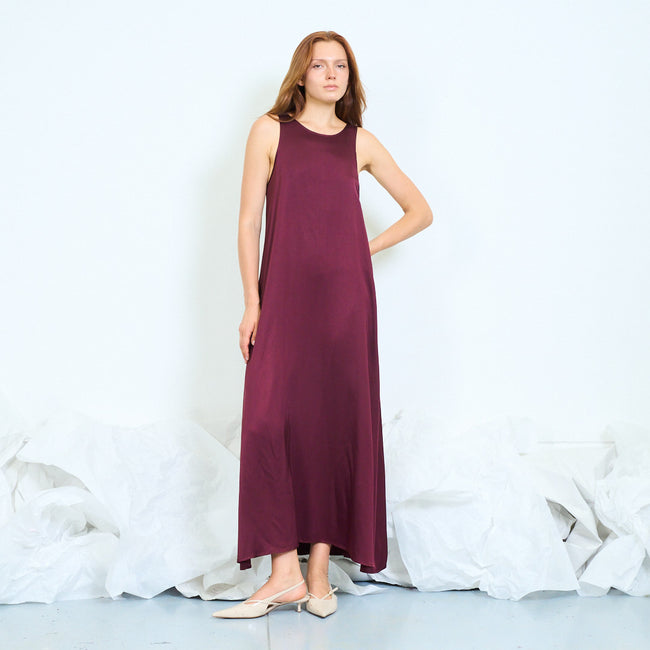 Bordeaux sleeveless scoop-neck long dress with broad shoulder straps and gently flared silhouette; shoes styled separately