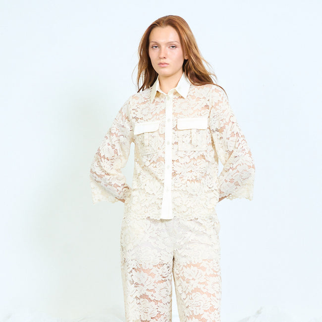 Cream floral lace button-front shirt with contrast pointed collar, plain front placket, contrast chest flap details, flared cropped sleeves and scalloped hem; coordinating lace trousers and shoes styled separately