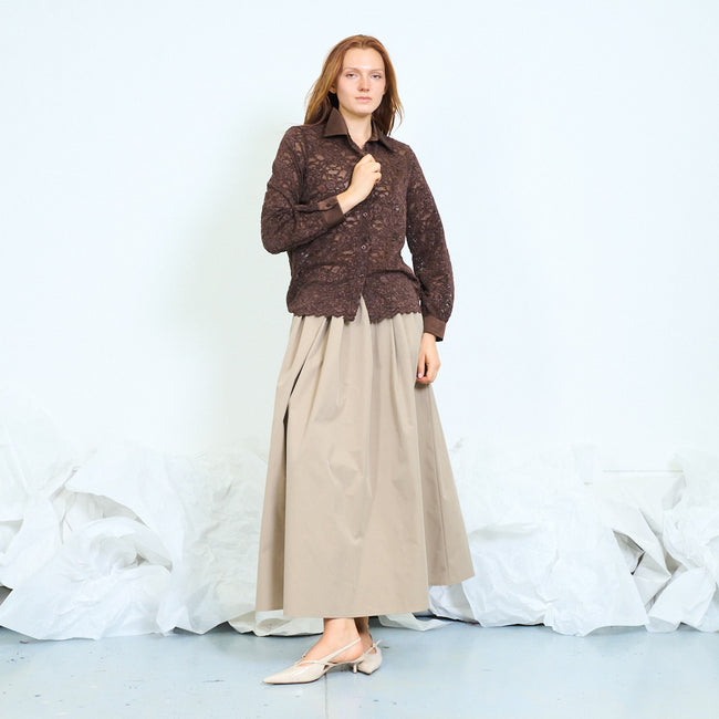 Coffee brown floral lace shirt with contrast pointed collar, front buttons, long lace sleeves, plain cuffs and scalloped hem; beige long skirt and shoes styled separately