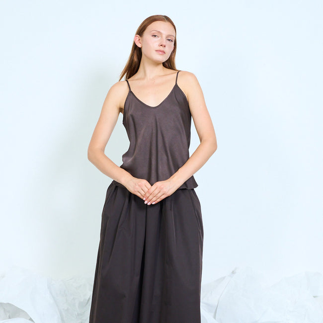 Coffee brown plain V-neck camisole with narrow shoulder straps and relaxed silhouette; coordinating long skirt and shoes styled separately