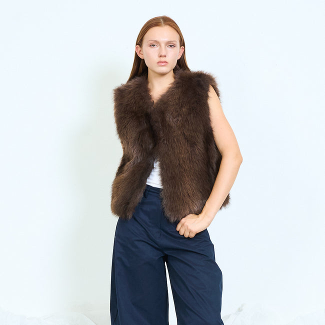 Coffee dark brown long-pile faux-fur open-front sleeveless vest with short silhouette; plain top, trousers and shoes styled separately