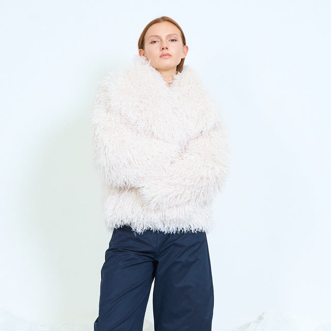 White short open-front long-pile textured coat with long voluminous sleeves; plain top, jeans or trousers and shoes styled separately