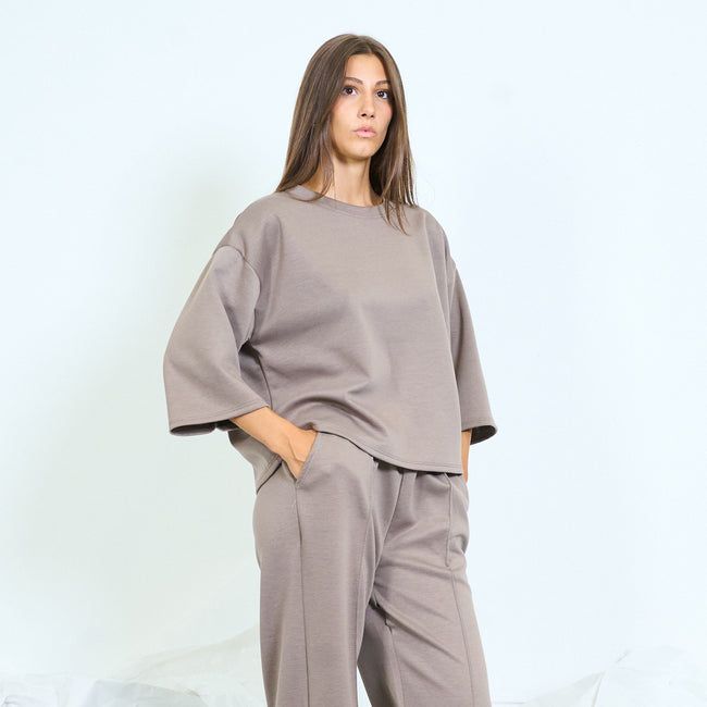 Taupe boxy top with wide three-quarter sleeves.