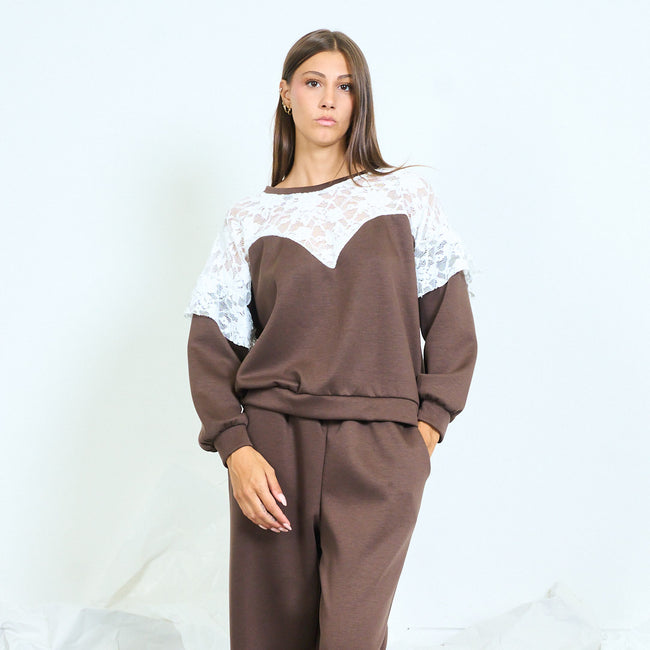 Brown long-sleeve top with a white floral lace yoke.
