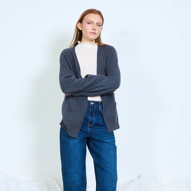 Blue-gray open-front cardigan shown with arms folded.