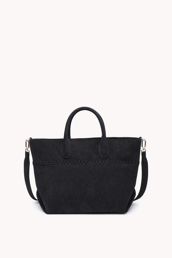 Front view of a black trapezoid tote with rounded handles, a shoulder strap and woven trim.