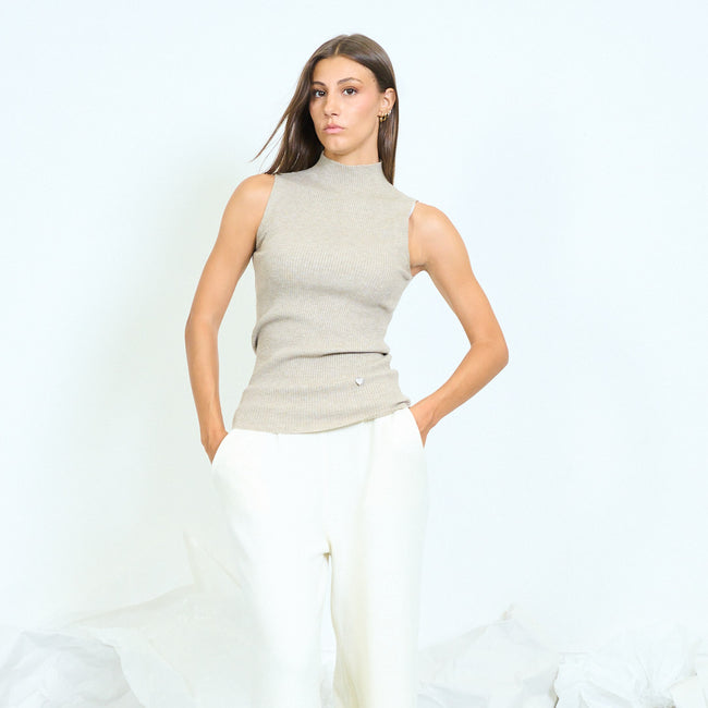 Front view of a light taupe sleeveless ribbed top with a high neckline.