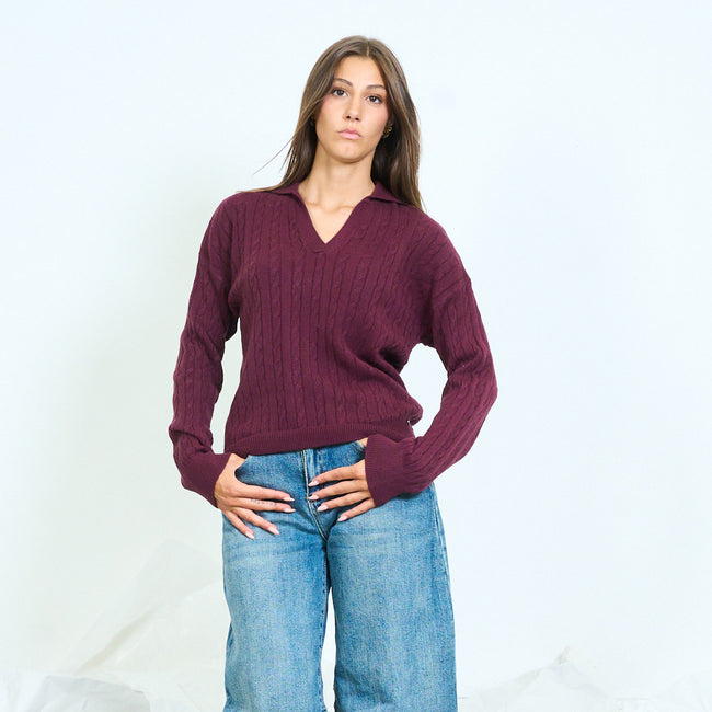 Front view of a purple cable-knit sweater with an open collar.