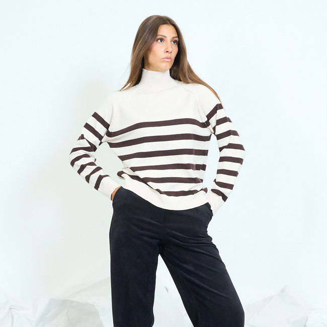 Front view of a cream high-neck sweater with dark horizontal stripes.