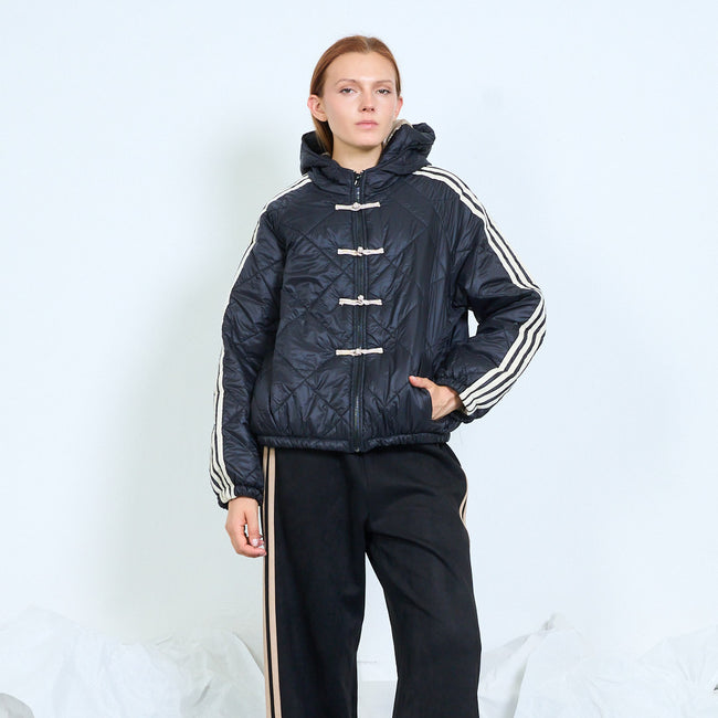 Front view of a dark quilted hooded jacket with cream sleeve stripes and toggle fastenings