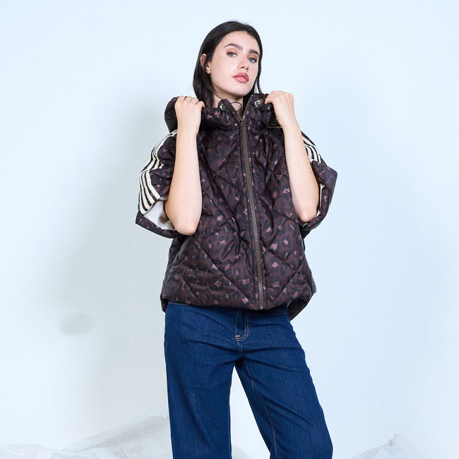 Model wearing a dark leopard-print quilted hooded jacket with short sleeves and contrasting shoulder stripes.
