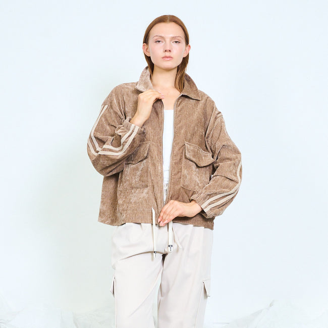 Tan textured zip-front jacket with flap pockets and contrasting sleeve stripes.