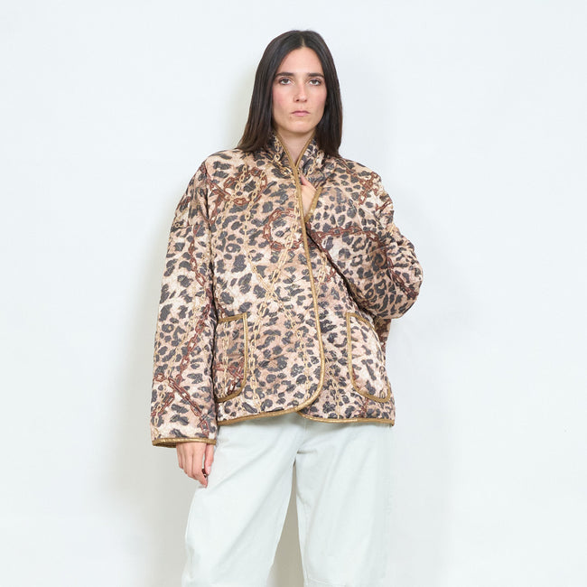 Model wearing a leopard-and-chain-print jacket with contrasting edging and patch pockets.