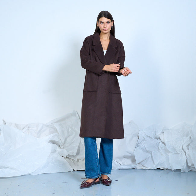 Dark brown long coat with wide lapels and patch pockets, front view