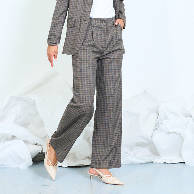 Side view of gray-brown checked trousers with straight legs and slanted pockets.