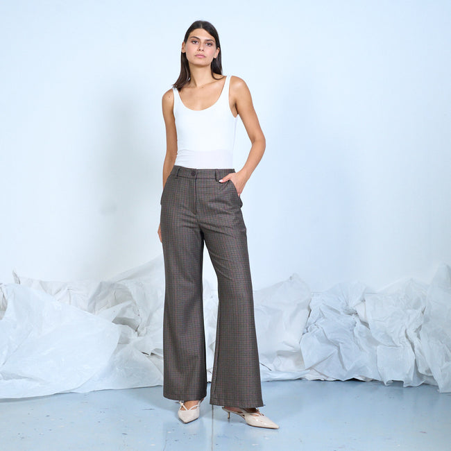 Dark brown checked wide-leg trousers worn with a white sleeveless top